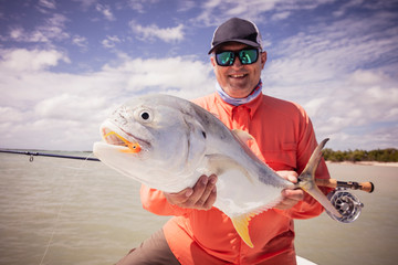 Man holding fish caught in salt water fly fishing, caribbean