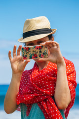 girl in a hat taking picture