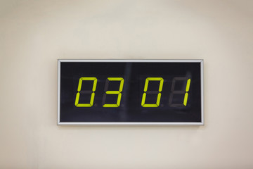 Black digital clock on a white background showing time 03 01