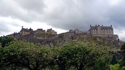 Fototapeta na wymiar Panoramic view of Edinburgh Castle under cloudy sky, typical weather in Scotland