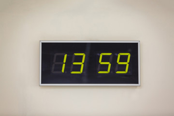 Black digital clock on a white background showing time 13.59 minutes