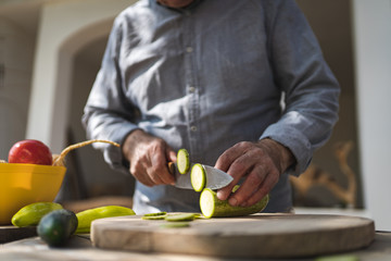 Senior man preparing food outdoors