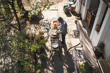 Fototapeta na wymiar Senior man preparing food outdoors
