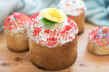 Easter cupcakes with sugar flowers on a wooden table