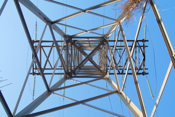 electricity pylon against blue sky