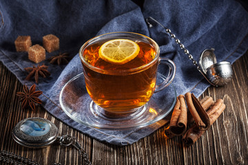 tea with lemon, cinnamon, sugar, star anise and a pocket watch with a chain