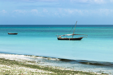 Fototapeta na wymiar Wooden boats on turquoise water in Zanzibar