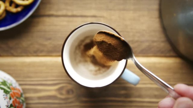 Top view Slow motion pours instant coffee into cup