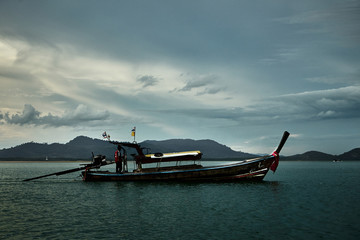 Thai national boat sailing around the bay