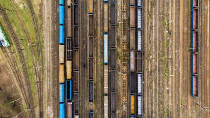 Obraz premium Aerial view of colorful freight trains on the railway station.
