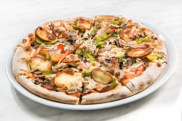 Homemade pizza on white plate