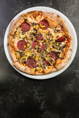 Restauran pizza on dark marble, copy space