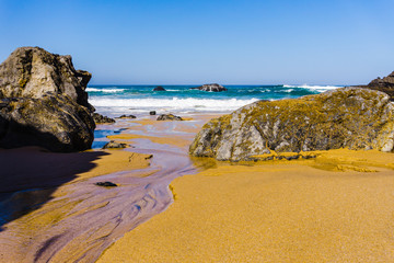 Rocky coastline of sandy Adraga beach, Portugal