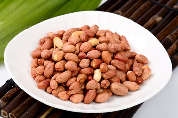peanuts in bowl on wooden table