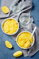 Salmon potato casserole with glasses of water