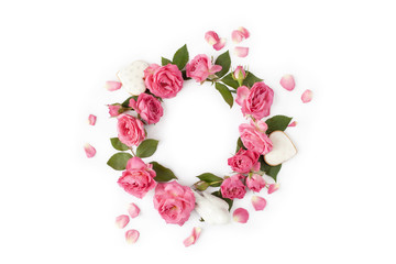 Floral wreath made of roses and leaves. Natural round frame isolated on white. Holiday concept.