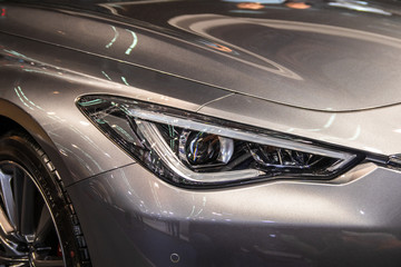 Obraz na płótnie Canvas Headlight of grey modern car with LED light