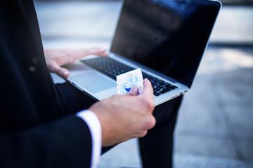 Businessman using credit card to shop online