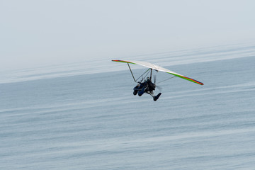 An ultralight trike in flight over the Florida coast.