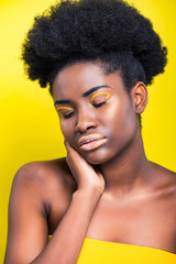 beautiful african american woman with closed eyes isolated on yellow