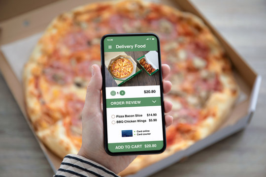 Female Hands Holding Phone With Delivery Food App Pizza Box