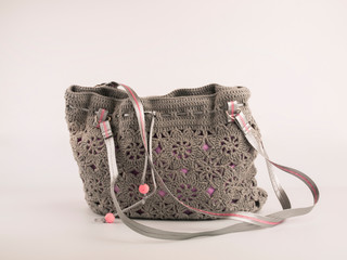 Women's accessories: knitted bag on a white background. Handmade. Fashion. Advertising