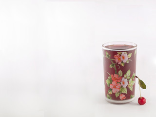 A glass with compote, cherry on a white background. Copy space