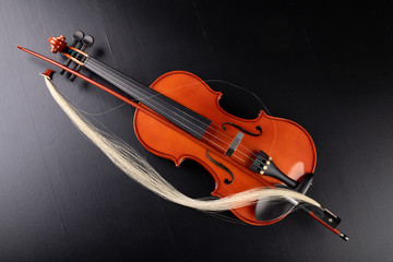 Broken bow to the violin. Damaged musical instrument.