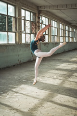 Ballerina dancing in an old building. Young, elegant, graceful woman ballet dancer