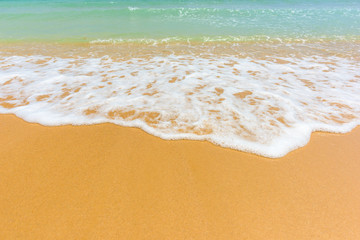 Wave of the sea on the sand beach background