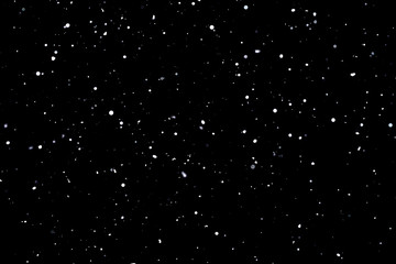 Naklejka na ściany i meble Falling snow on black background Snowflakes Flying in the air.