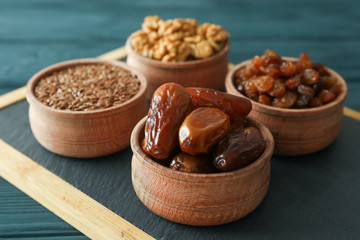 Cutting board with healthy food on wooden background, closeup