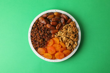 Marble tray with healthy food on green background, top view