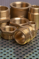 Plumbing brass fittings close-up on metallic surface