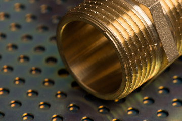 Brass fittings close-up on metallic surface