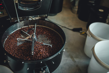 Coffee roasting in small roastery. Coffee roasting machine, Production of coffee.