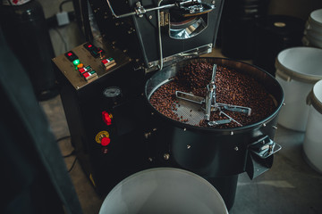 Coffee roasting in small roastery. Coffee roasting machine, Production of coffee.