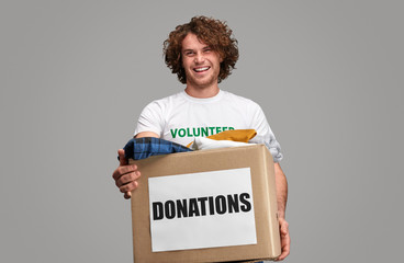 Smiling volunteer with donations box