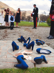 Bride and Bridesmaid shoes discarded at a military wedding