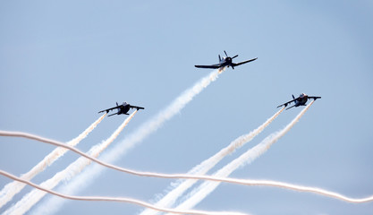 three airplanes in formation with smoke