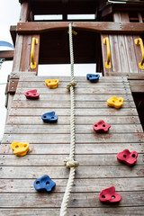 Looking up a wooden children's climbing frame with rope
