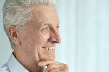 Close up portrait of smiling senior man posing