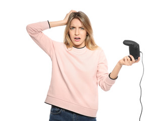 Emotional young woman playing video games with controller isolated on white