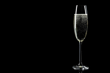 Glass of champagne on black background, space for text