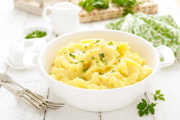 Mashed potato with butter and milk on table