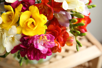 Beautiful spring freesia flowers on stand, closeup
