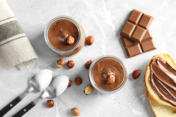 Sweet chocolate mousse served on marble table, flat lay