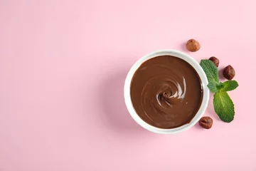 Fotobehang Dessert bowl with sweet chocolate cream, hazelnuts and mint on color background, top view. Space for text © New Africa