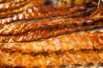 Hot juicy grilled pork ribs on the grill. Grilled meat. Tasty hot food. Hearty lunch.