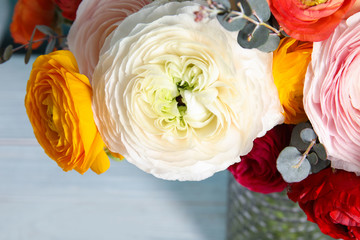 Bouquet with beautiful ranunculus flowers on table, closeup